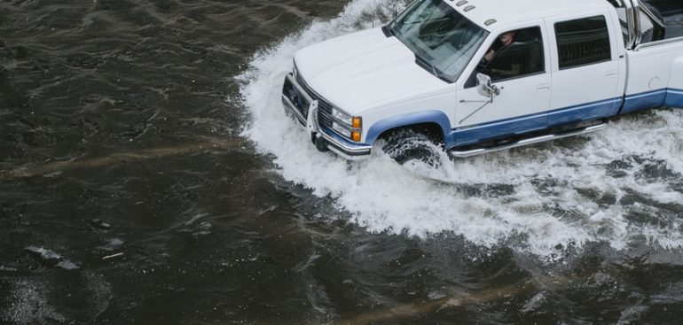 truck driving thru flood