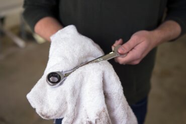 mechanic with wrench and towel