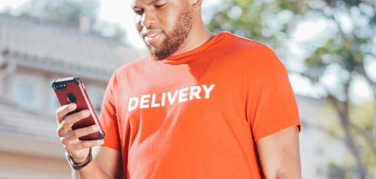 delivery driver checking their phone,